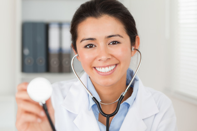 beautiful-female-doctor-using-a-stethoscope-while-looking-at-the-camera_13339-185899